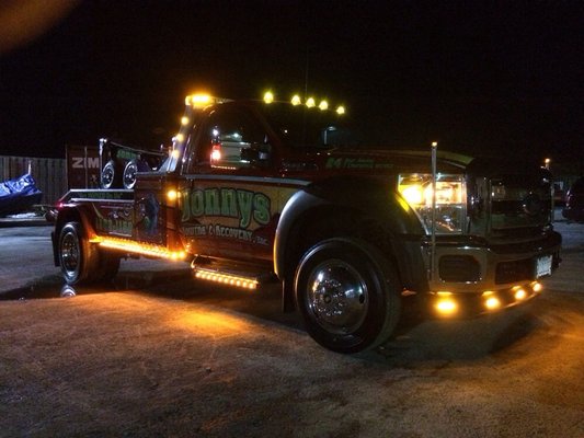 Jonny's Towing truck at night